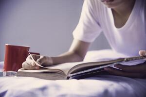 Teens read books on the bed in the bedroom. photo