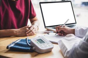 The doctor is discussing with the patient after a physical examination of the results and treatment guidelines. photo