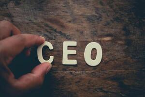 Place the word CEO white on the wooden floor. photo