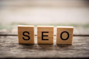 Place the word  S E O on the wooden floor - concept Search Engine Optimization photo