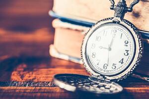 Antique clock handles placed on the wood floor - vintage style. photo