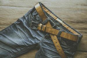 Jeans for men on a wooden floor photo