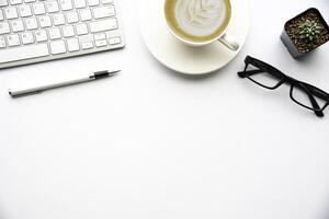 Top view with copy space, working desk with laptop,cell phone,notebook pencil and coffee on white background photo