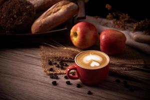 Red coffee glass rests on wood floor. concept still life photo