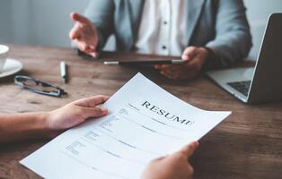 Human resource manager Is explaining the job to the job seeker before filling out a resume on the application form to consider accepting for employment in the company. photo