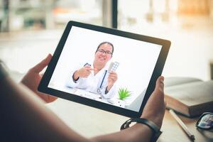 The patient's viewpoint consult with the doctor via social media such as laptop, smartphone, almost. The work for home concept of doctors and patients. photo