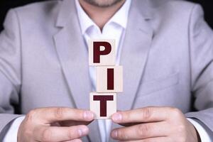 PIT, businessman building business word from cubes photo