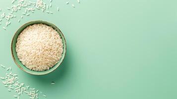 AI generated Bowl of uncooked white rice on textured green background. Top view. Concept of culinary staple, raw rice presentation, healthy food ingredient. Banner with copy space. photo