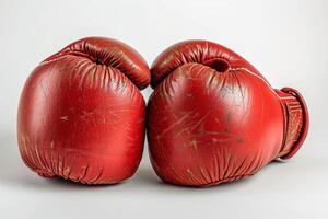 ai generado rojo boxeo guantes aislado en blanco antecedentes. concepto de boxeo equipo, combate Deportes engranaje, formación accesorio, y desgastado atlético artículos foto