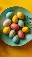 AI generated Colorful Easter eggs in a bowl against a vibrant yellow backdrop. Top view. Vertical format. Ideal for seasonal marketing, holiday Easter recipes, or creative craft inspiration photo