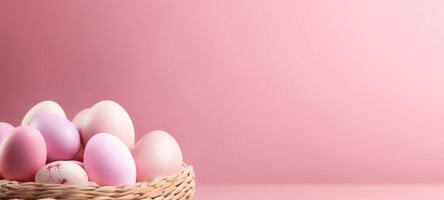 AI generated Soft-hued Easter eggs in a basket, set against pink backdrop. Banner with copy space. Ideal for springtime greetings and tender holiday imagery, conveying calmness photo