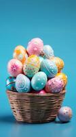 AI generated Wicker basket filled with pastel-colored hand-painted Easter eggs on a turquoise background. With copy space. Can be used for Easter holiday promotions and seasonal decor themes. photo