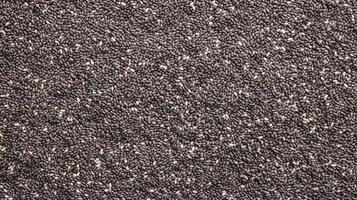 AI generated Top view of Chia seeds. Background texture of raw Chia seeds. Superfood. Copy space. Banner. Ideal for culinary and food concepts photo