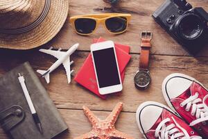 Travel accessories on wooden floor ready for travel photo