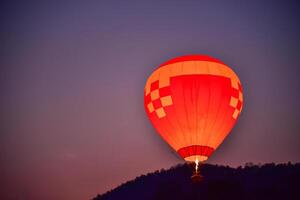 The balloon is floating in the sky in the early morning. photo