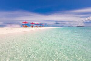 Beautiful tropical beach scenery. sun beds, loungers, umbrella under palm tree. White sand, sea view with horizon, colorful sunshine sky, calmness and relaxation. Inspirational beach resort hotel photo