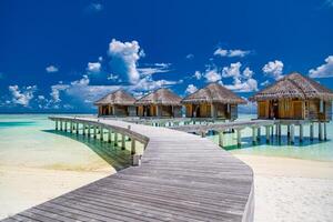 Panoramic landscape of Maldives sunny sea sky beach. Tropical panorama, luxury water villa resort wooden pier. Luxury travel destination background photo