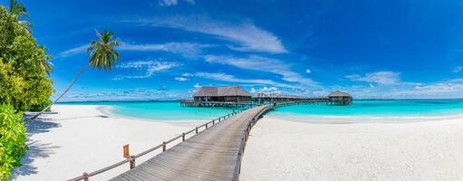 Amazing panorama landscape of Maldives beach. Tropical beach landscape seascape, luxury water villa resort wooden jetty. Luxurious travel destination background for summer holiday and vacation concept photo