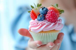 AI generated Hand holds a cupcake with colored icing and fresh fruits. Generative AI photo