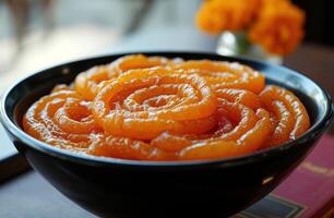 AI generated Black bowl filled with delicious jalebi, gudi padwa sweets and cuisine image photo