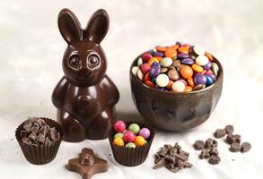 AI generated Chocolate bunny and candies on a white background are sweet treats for easter celebration, easter chocolates picture photo