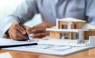 AI generated Man signing over house model with pen, home loan paperwork concept photo