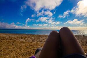 Woman sunbathing on the beach photo