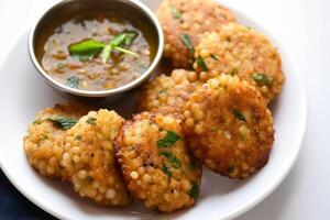 AI generated Delicious sabudana wada sago fritters with coconut chutney for a tasty and crunchy snack, gudi padwa sweets and cuisine photo