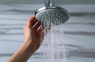 AI generated Hand holding shower head, water conservation image photo