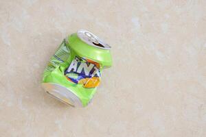 KYIV, UKRAINE - 4 MAY, 2023 Fanta soft drink brand crumpled tin can with exotic flavour photo