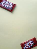 KHARKIV, UKRAINE - JANUARY 2, 2021 Kit Kat by Nestle chocolate covered wafer on bright color photo