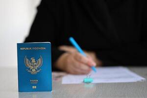 Indonesia passport and service workers table on process of citizenship registration photo