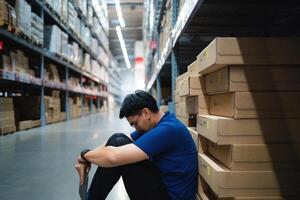 warehouse worker tired from work Being fired from work. Unemployment. Failure. Desperation for work. photo