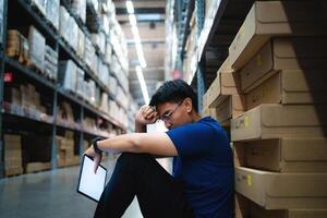 warehouse worker tired from work Being fired from work. Unemployment. Failure. Desperation for work. photo