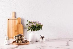 Stylish kitchen background for Easter holiday with traditional symbols and white tableware. foreground. Easter holiday concept. A copy space. photo