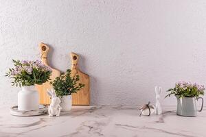 Stylish kitchen background for Easter holiday with traditional symbols and white tableware. foreground. Easter holiday concept. A copy space. photo