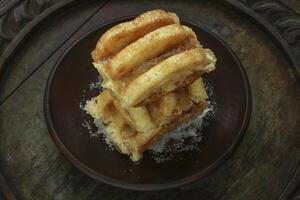 Kue Rangi, is Indonesian traditional street food, made from rice powder and grated coconut served with sugar. photo