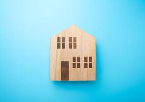 Wooden figures of houses. Buying and selling. Housing options. Affordable housing. Mortgage. Realtor services. photo