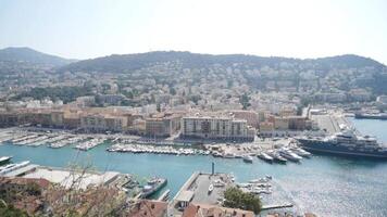 Top view of sea city with moored yachts. Action. Panoramic view of old town located on sea coast with yachts on shore. Yachts and ships in seaport near old town on sunny summer day video