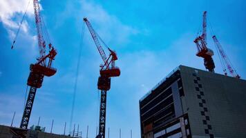 A timelapse of crane at the top of the building at the business town in Tokyo zoom video