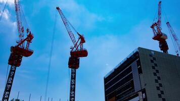 A timelapse of crane at the top of the building at the business town in Tokyo zoom video