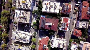 Top view of roofs of high-rise residential buildings in city center. Clip. In center of southern resort town houses roofs and moving cars on roads video