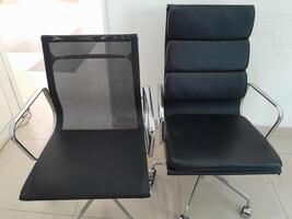 Photo of two black work chairs. Perfect for magazines, newspapers, adverts and tabloids.