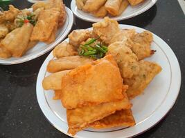 Fried food or Gorengan typical of Indonesia made from wheat, tempeh, vegetables. This photo is perfect for magazines, newspapers, cookbooks, advertisements, banners, posters
