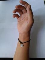 Photo of bracelet with zodiac pendant. This photo is suitable for advertising photos, calendars, magazines, posters, banners