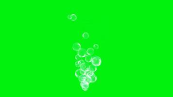 Blue bubbles are sprayed on the green screen of chroma particles video