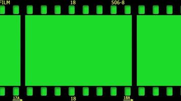 Old cinema negative film strip motion vertical horizontal green screen keylight video