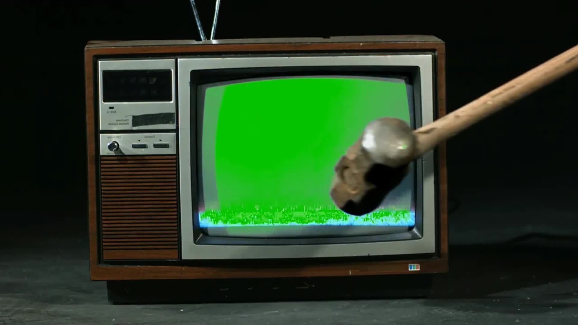 Hitting with a hammer and breaking the old TV screen Green screen