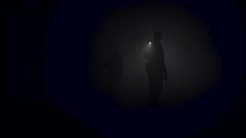 A lonely man exploring deep dark cave. Stock footage. Silhouette of a person standing inside of the cave on the background of the mystical moonlit. video