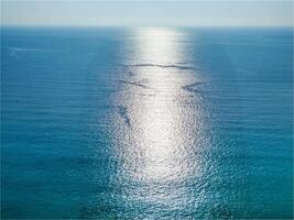 Aerial shot of the sea with the sun photo